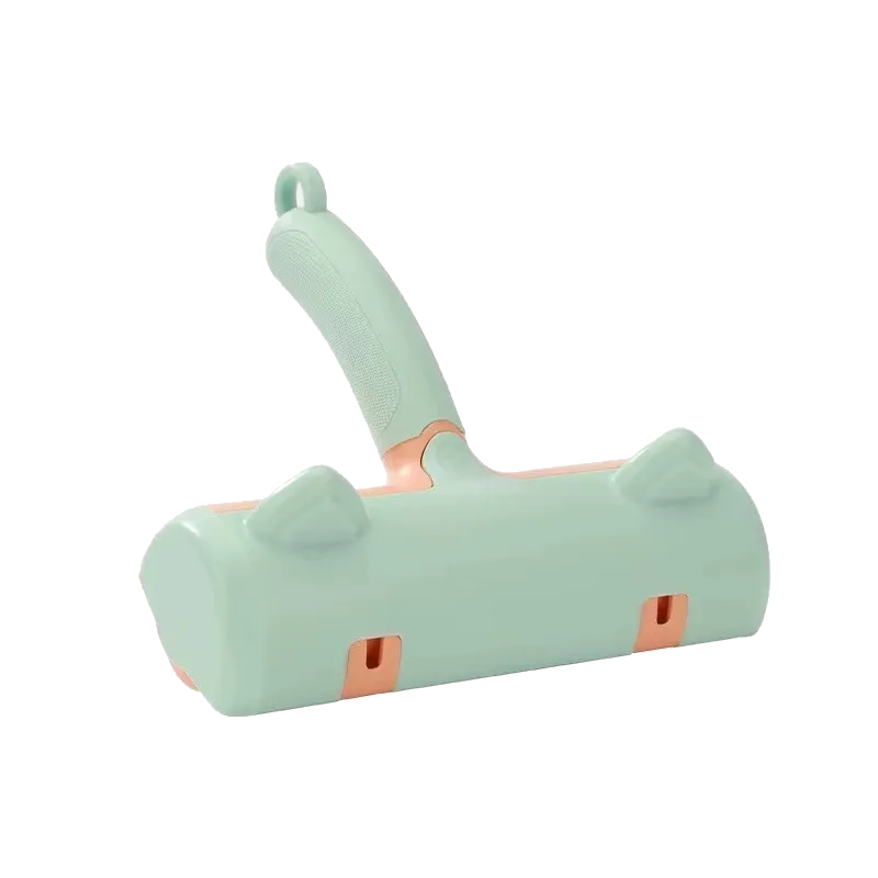 Mint-green manual fur brush with peach accents and cat-ear detailing