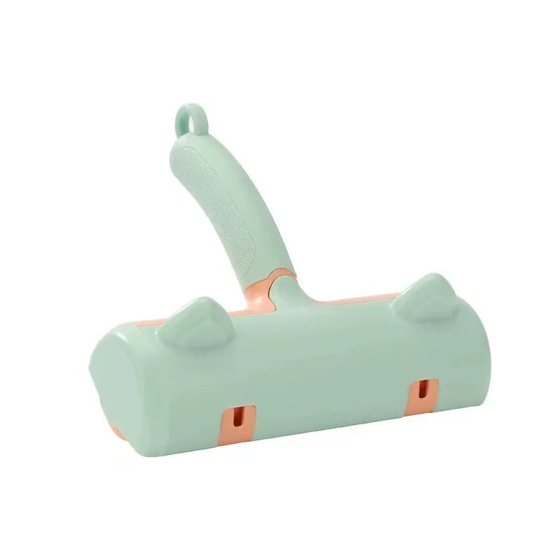 Mint-green manual fur brush with peach accents and cat-ear detailing, shown from the front